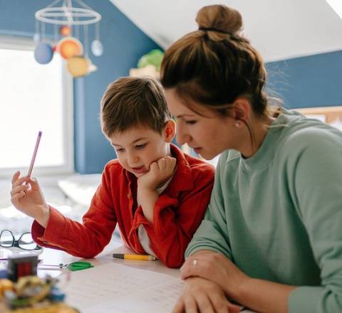 Mother helping her son stay focused and on task while completing his homework