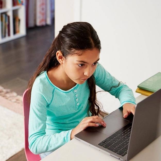 Child completing homework on a computer