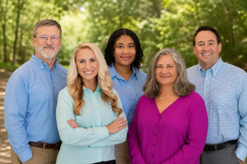 Calhoun Psychology team standing together outdoors in a natural setting.