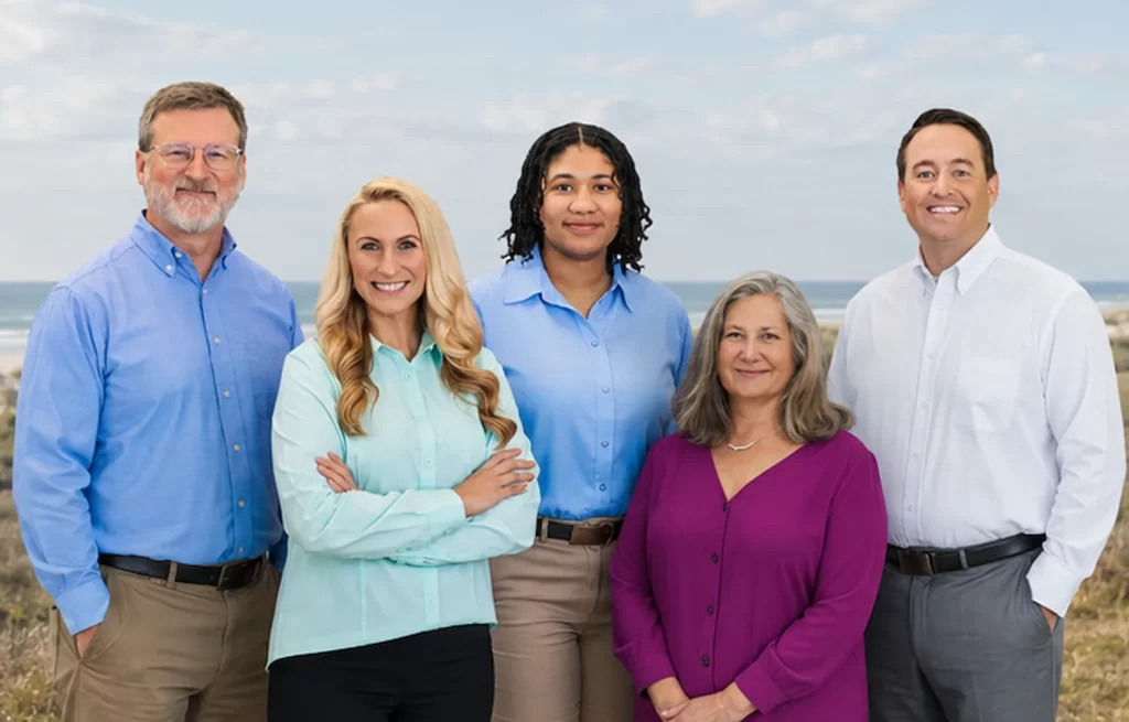 Calhoun Psychology team standing together outdoors in a natural setting.